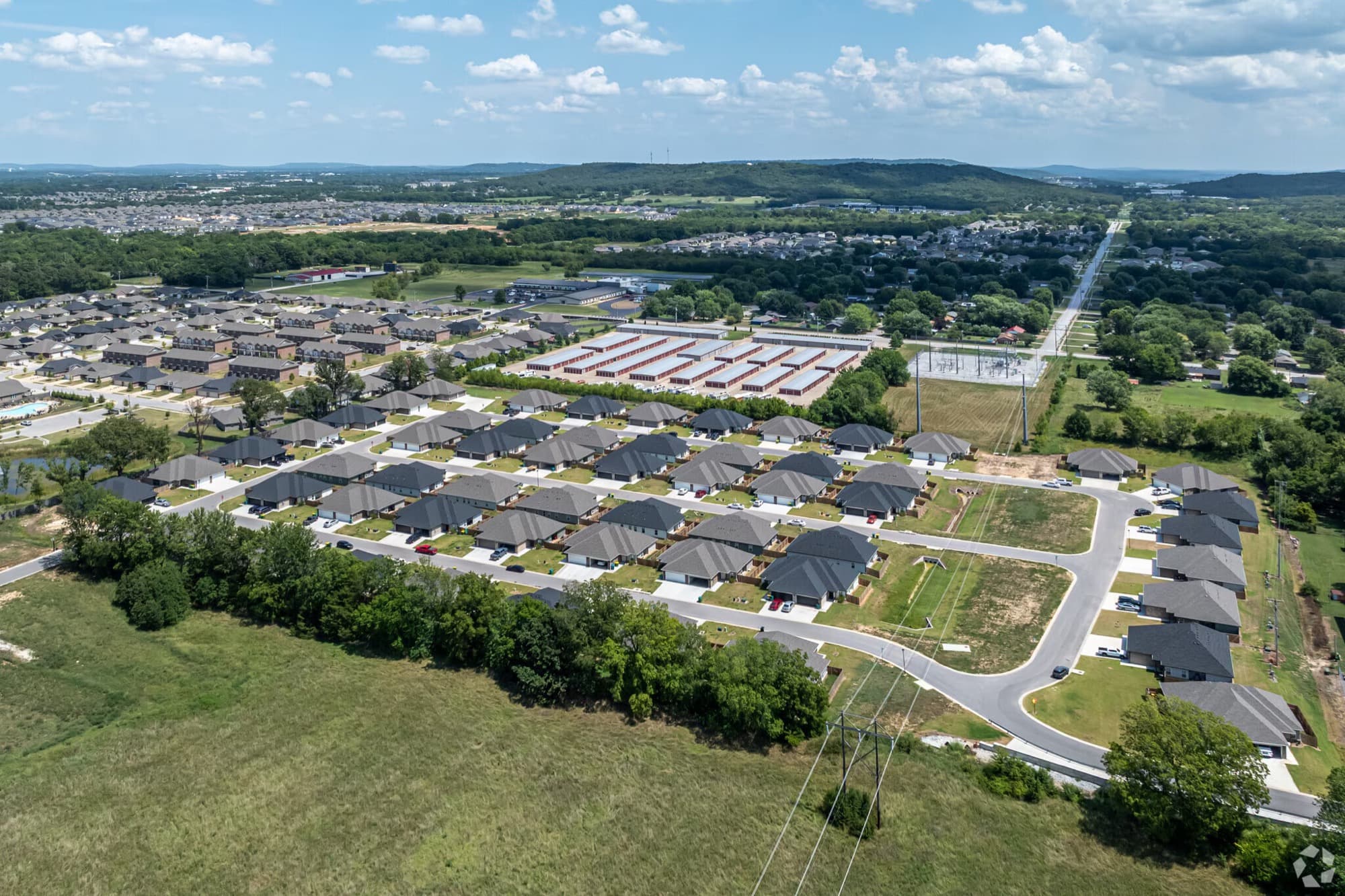 Aerial view of the gated Farmington Hills community with the Ozark foothills beyond