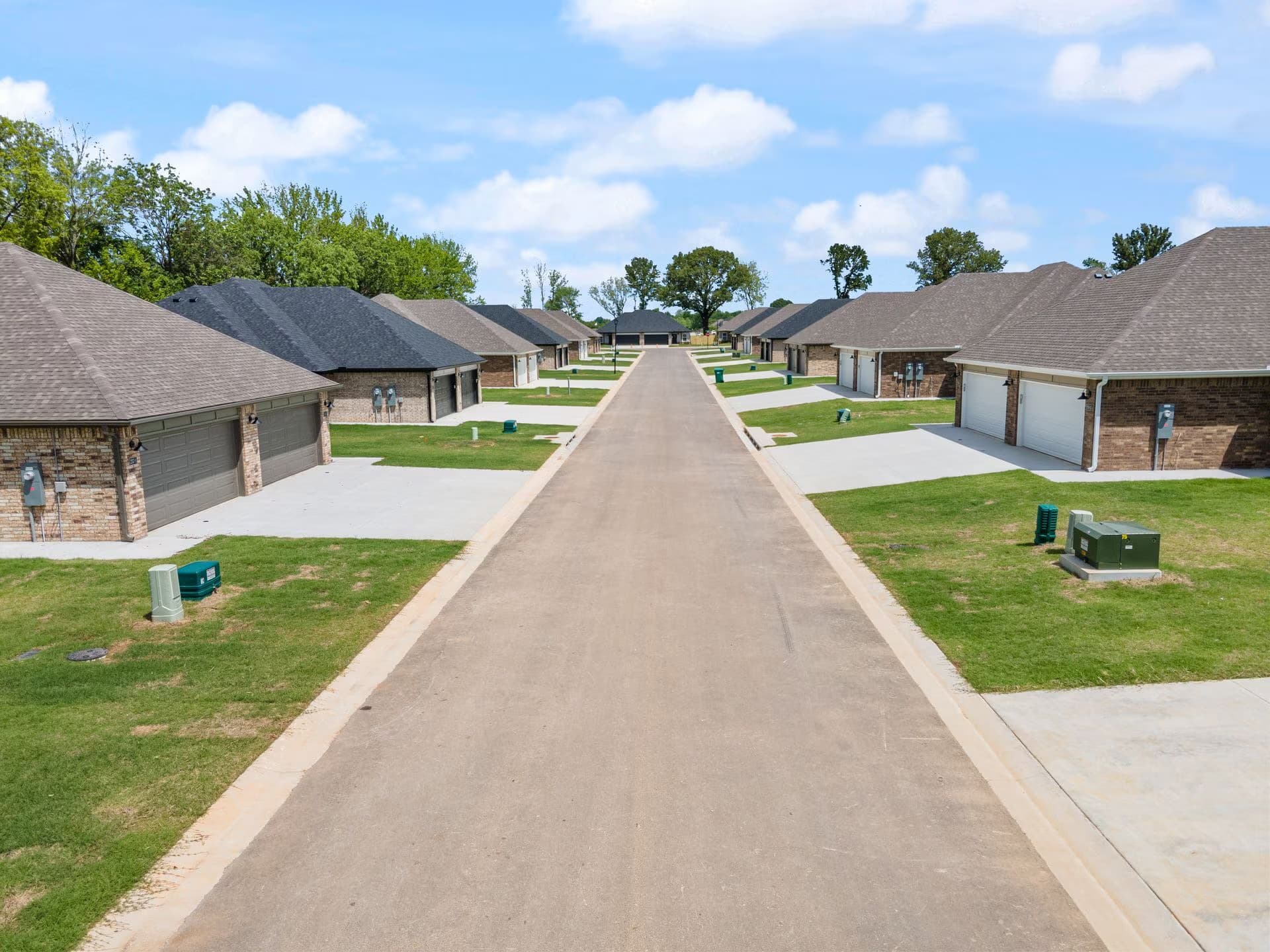 A new residential street in Farmington with brick homes and wide driveways